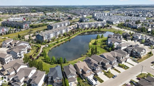 Developed neighborhood featuring a central lake, extensive green spaces, a network of walking paths, and a mix of single-family homes and multi-story apartment buildings - 3456 Cutler Crescent, Edmonton, AB - Outdoor With View