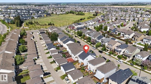 Aerial perspective showcasing a residential neighborhood with varied architectural styles and a nearby green space - 3456 Cutler Crescent, Edmonton, AB - Outdoor With View