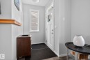 Entryway featuring a white paneled door with glass inserts, a single transom window, and a vertical window with blinds - 3456 Cutler Crescent, Edmonton, AB  - Indoor Photo Showing Other Room 