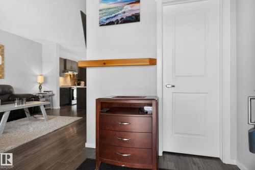 White interior door with chrome hardware, wood-finish flooring, and light gray wall paint - 3456 Cutler Crescent, Edmonton, AB - Indoor Photo Showing Other Room