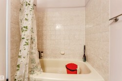 Bathtub with beige subway tile surround - 