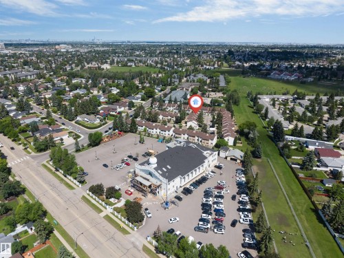 Aerial view of the neighborhood featuring a dense residential area, mature trees, and open green spaces - 24 1651 46 Street, Edmonton, AB 