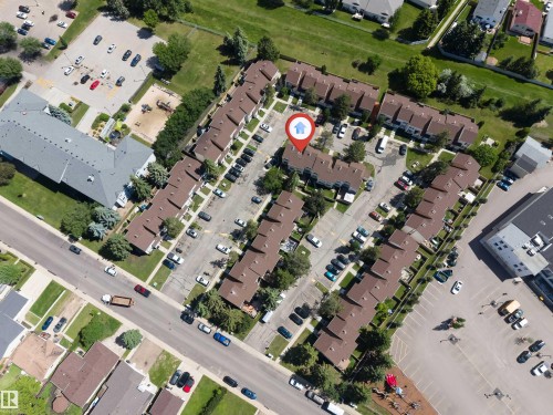 Aerial perspective showcasing a residential community with brown-roofed townhomes - 24 1651 46 Street, Edmonton, AB 