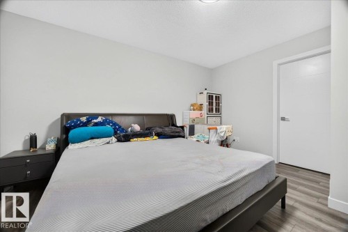 Room featuring light gray painted walls and wood-finish flooring - 18139 75 Street, Edmonton, AB 