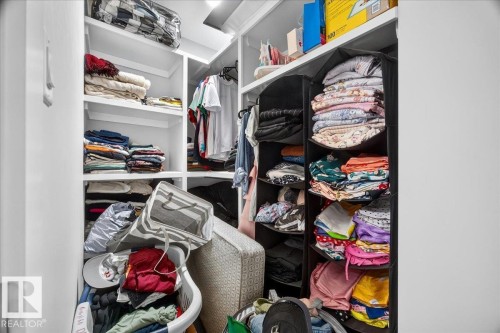 Built-in closet system with multiple white shelving units and hanging rods - 18139 75 Street, Edmonton, AB 