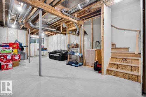 Unfinished basement with concrete flooring and visible structural beams and ductwork - 18139 75 Street, Edmonton, AB 
