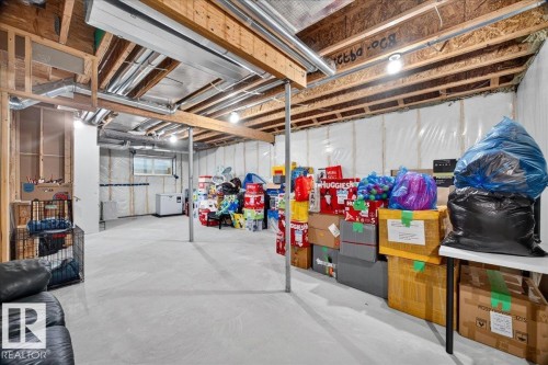 Unfinished basement featuring exposed wood joists, concrete flooring, and ample space for customization - 18139 75 Street, Edmonton, AB 