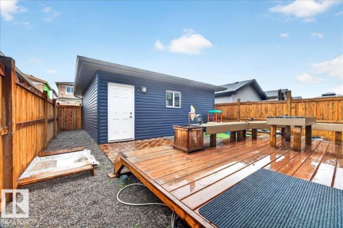 Detached accessory building featuring blue horizontal siding and a white entry door - 18139 75 Street, Edmonton, AB 