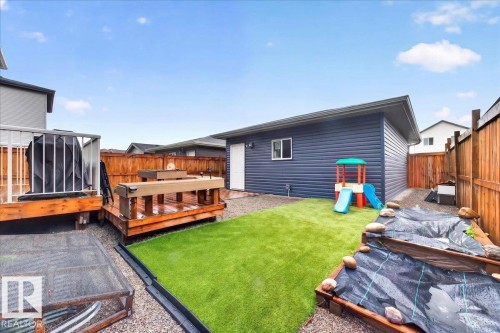 Expansive backyard featuring a multi-level wood deck, artificial turf area, and perimeter wood fencing - 18139 75 Street, Edmonton, AB 
