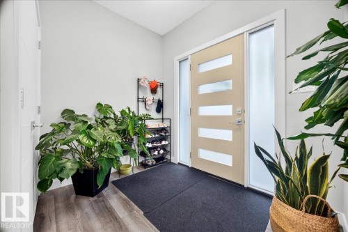 Contemporary front entry featuring a modern door with frosted glass panels and sidelights - 18139 75 Street, Edmonton, AB 