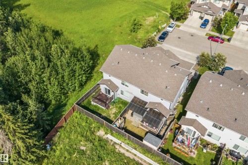 Rear elevation with a screened-in porch, open deck, and fenced yard - 25 Halladay Boulevard, Spruce Grove, AB - Outdoor With View
