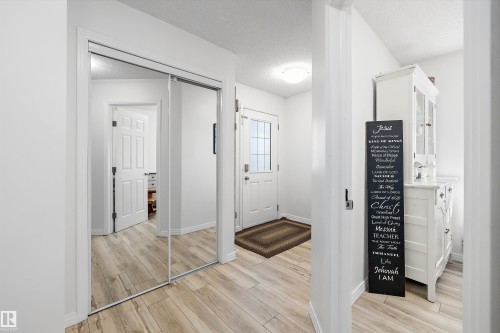 Entryway featuring wood-finish flooring, a full-lite exterior door with privacy glass, and a flush-mount ceiling light fixture - 25 Halladay Boulevard, Spruce Grove, AB - Indoor Photo Showing Other Room