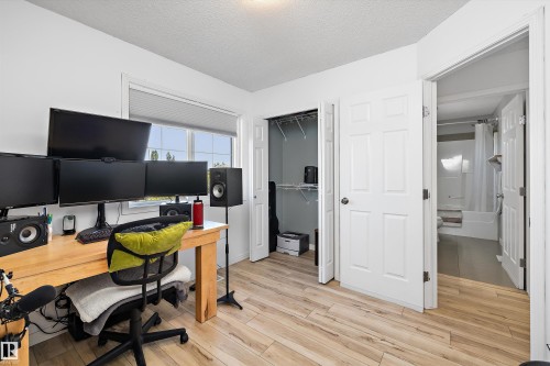 Light wood-finish flooring throughout this room, featuring a window with cellular shades - 25 Halladay Boulevard, Spruce Grove, AB - Indoor Photo Showing Office