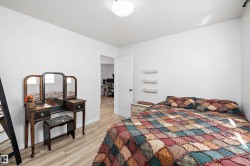 Bright room featuring light wood-finish flooring, white walls, and a flush-mount ceiling light fixture - 