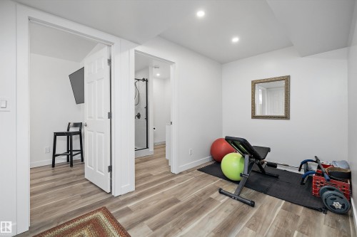 Dedicated space featuring wood-finish flooring, recessed lighting, and a neutral color palette - 25 Halladay Boulevard, Spruce Grove, AB - Indoor