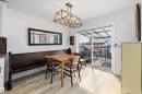Dining area featuring wood-finish flooring, a contemporary rectangular light fixture, and a built-in dark wood bench - 25 Halladay Boulevard, Spruce Grove, AB  - Indoor Photo Showing Dining Room 