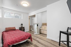 Room featuring wood-finish flooring, a contemporary flush-mount ceiling light, white baseboards, and a window with horizontal blinds - 