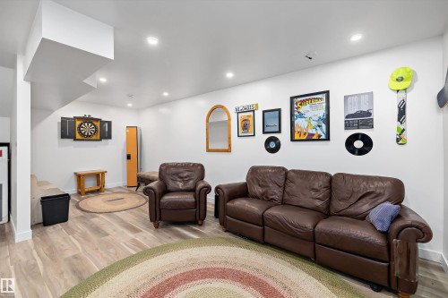 Spacious lower-level room featuring wood-finish flooring, recessed lighting, and bright white walls - 25 Halladay Boulevard, Spruce Grove, AB - Indoor