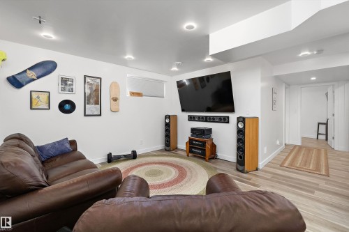 Spacious entertainment area with recessed lighting, light wood-finish flooring, and crisp white walls - 25 Halladay Boulevard, Spruce Grove, AB - Indoor