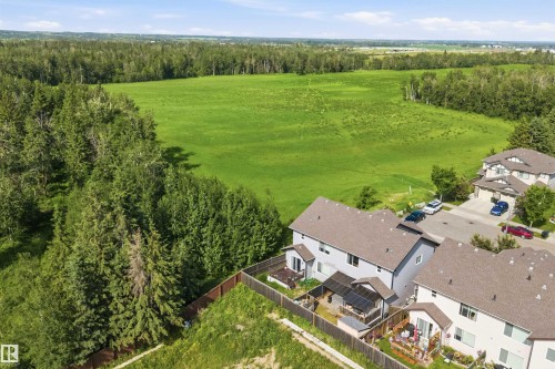 Aerial perspective showcasing residential properties bordering a verdant expanse of natural landscape - 25 Halladay Boulevard, Spruce Grove, AB - Outdoor With View