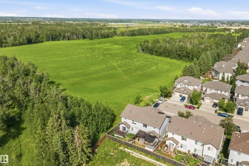 Residential neighborhood featuring detached homes with light-colored siding, brown roofs, and private fenced backyards - 25 Halladay Boulevard, Spruce Grove, AB - Outdoor With View
