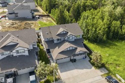 Modern multi-level residence with a dual-tone exterior finish and dark roofline - 