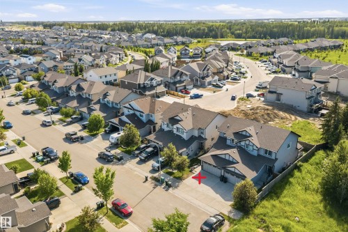 Contemporary suburban residence featuring a two-car garage, light-toned siding, and dark roofing - 25 Halladay Boulevard, Spruce Grove, AB - Outdoor With View