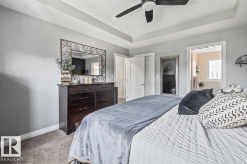 Tray ceiling with a ceiling fan, light gray wall paint, and gray carpeted flooring - 14 Edinburgh Crt N, St. Albert, AB 