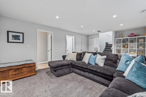 Spacious living area featuring neutral gray walls and plush gray carpeting - 14 Edinburgh Crt N, St. Albert, AB 