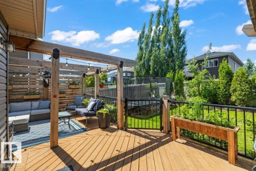 Expansive wood-finish deck featuring a pergola with string lighting - 14 Edinburgh Crt N, St. Albert, AB 