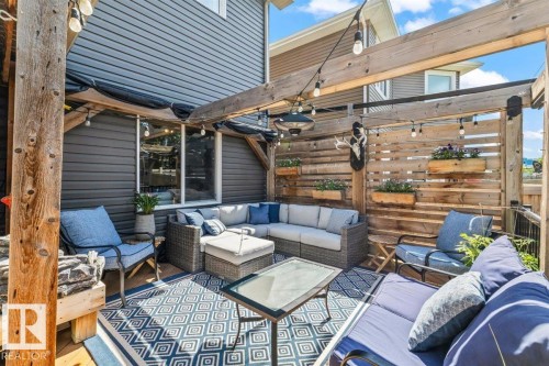 Outdoor patio area featuring a slatted wood privacy screen and perimeter lighting - 14 Edinburgh Crt N, St. Albert, AB 