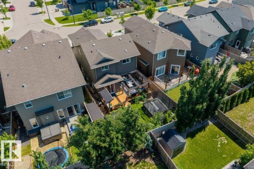 Rear exterior featuring a multi-level wood deck, privacy fencing, and a built-in hot tub - 14 Edinburgh Crt N, St. Albert, AB 