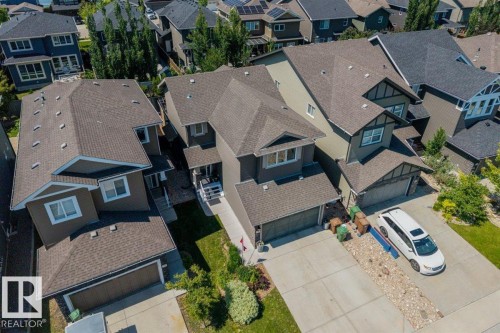 Contemporary brown home featuring a multi-gabled roofline and attached two-car garage - 14 Edinburgh Crt N, St. Albert, AB 