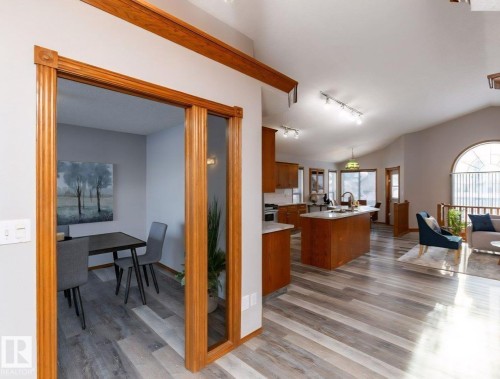 Open-concept living area with vaulted ceilings and wood-finish flooring - 49 Heritage Drive, St. Albert, AB 