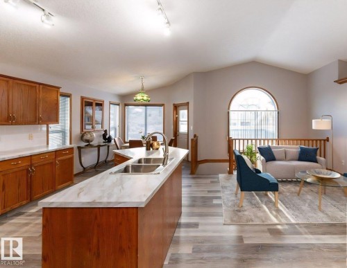 Kitchen featuring wood cabinetry, white countertops, and a double basin sink - 49 Heritage Drive, St. Albert, AB 
