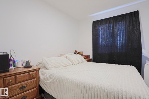 Bedroom featuring crisp white walls and a window with dark fabric covering - 33 Eton Link, Spruce Grove, AB 