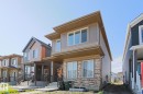 Contemporary two-story residence featuring a stone veneer facade on the lower level - 33 Eton Link, Spruce Grove, AB 