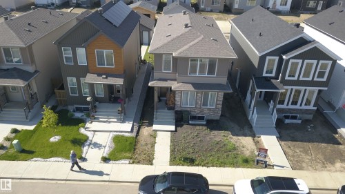 Contemporary two-story residence featuring a dark gray and wood-tone exterior facade - 33 Eton Link, Spruce Grove, AB 