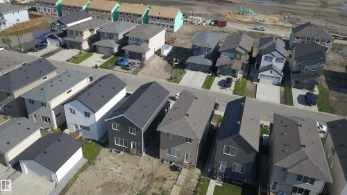 Aerial perspective showcasing a developing residential area with newly constructed homes - 33 Eton Link, Spruce Grove, AB 