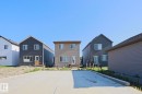 Expansive concrete parking pad with an adjacent gravel bed - 33 Eton Link, Spruce Grove, AB 