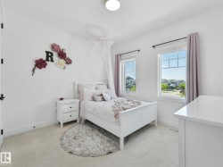 Bright room featuring two large windows, white walls, light-colored carpet, and a built-in ceiling light fixture - 