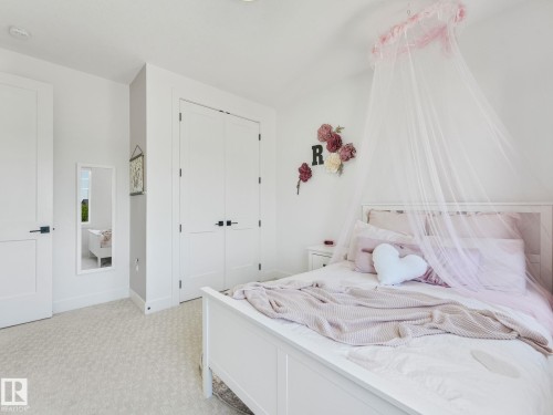 Bedroom featuring light-colored carpet, white walls, and recessed lighting - 5411 66 Street, Beaumont, AB 