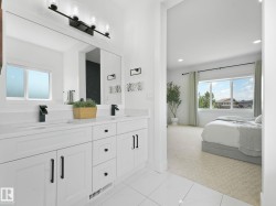 Contemporary bathroom vanity featuring dual undermount sinks, quartz-finish countertops, and matte black fixtures - 