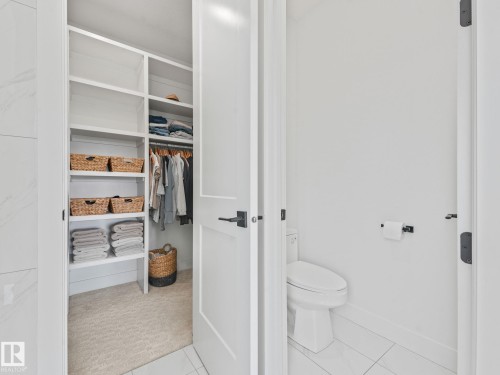 Custom closet system featuring built-in shelving and hanging rods - 5411 66 Street, Beaumont, AB 