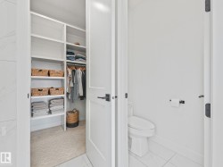 Custom closet system featuring built-in shelving and hanging rods - 