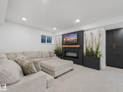 Contemporary living space featuring a shiplap accent wall with an electric fireplace and wood mantle - 