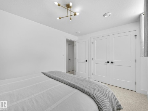 Interior space featuring white walls and neutral-toned carpet - 5411 66 Street, Beaumont, AB 