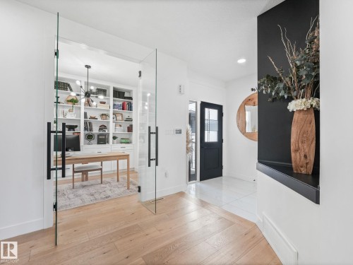 Entryway featuring light wood-finish flooring transitioning to white tile - 5411 66 Street, Beaumont, AB 