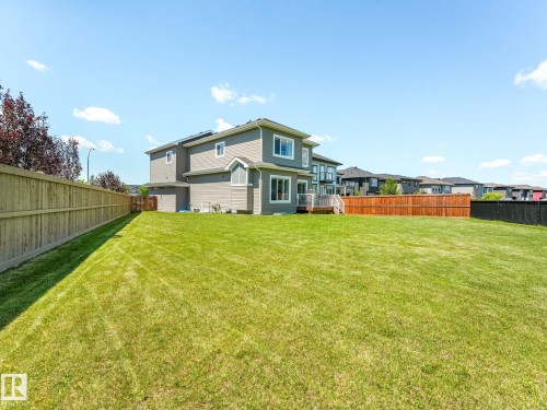 Expansive green lawn with a privacy fence - 5411 66 Street, Beaumont, AB 