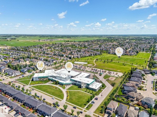 Aerial perspective showcasing a residential community with abundant green spaces - 5411 66 Street, Beaumont, AB 